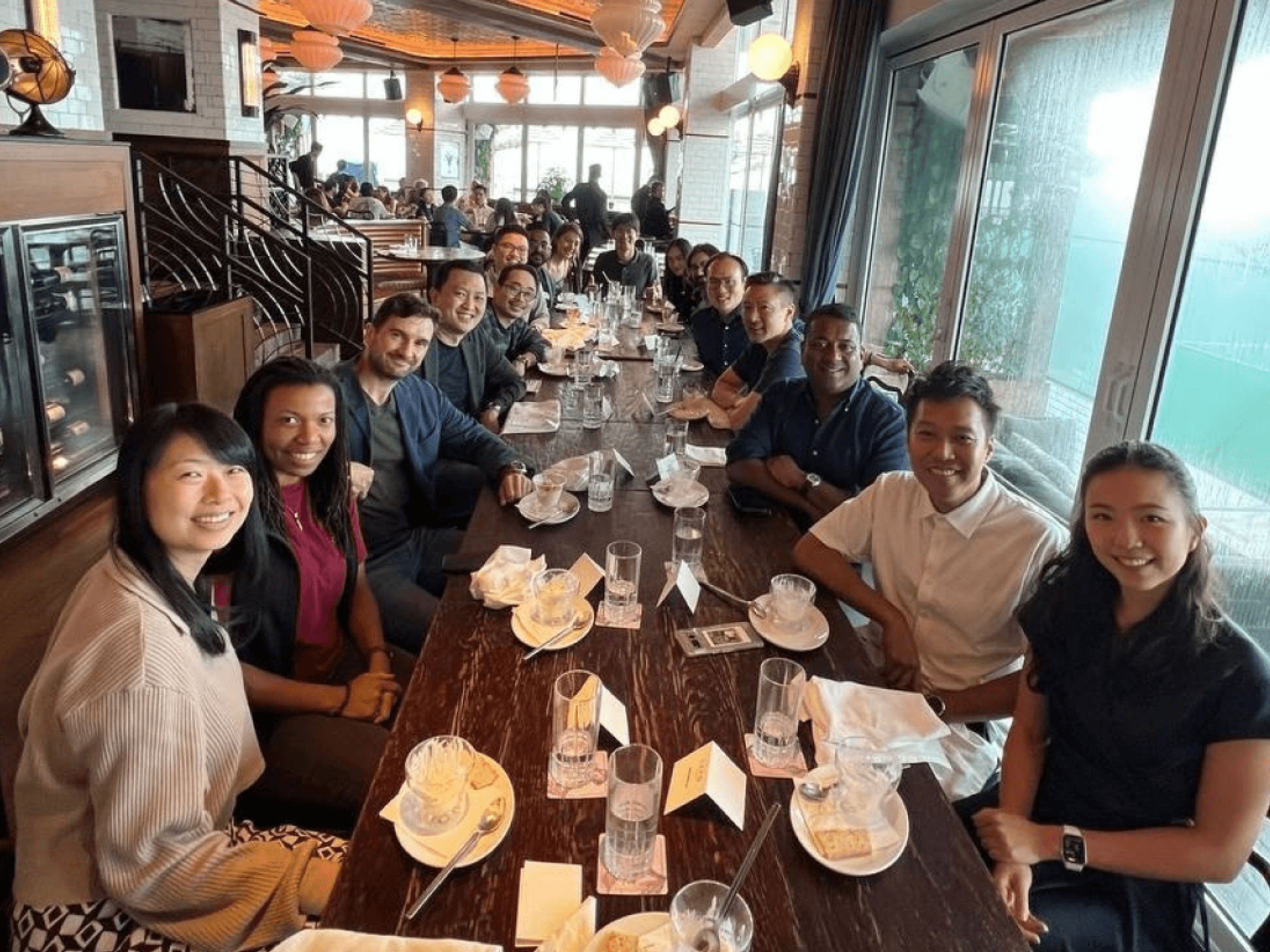 W3A members gathered around a long dinner table