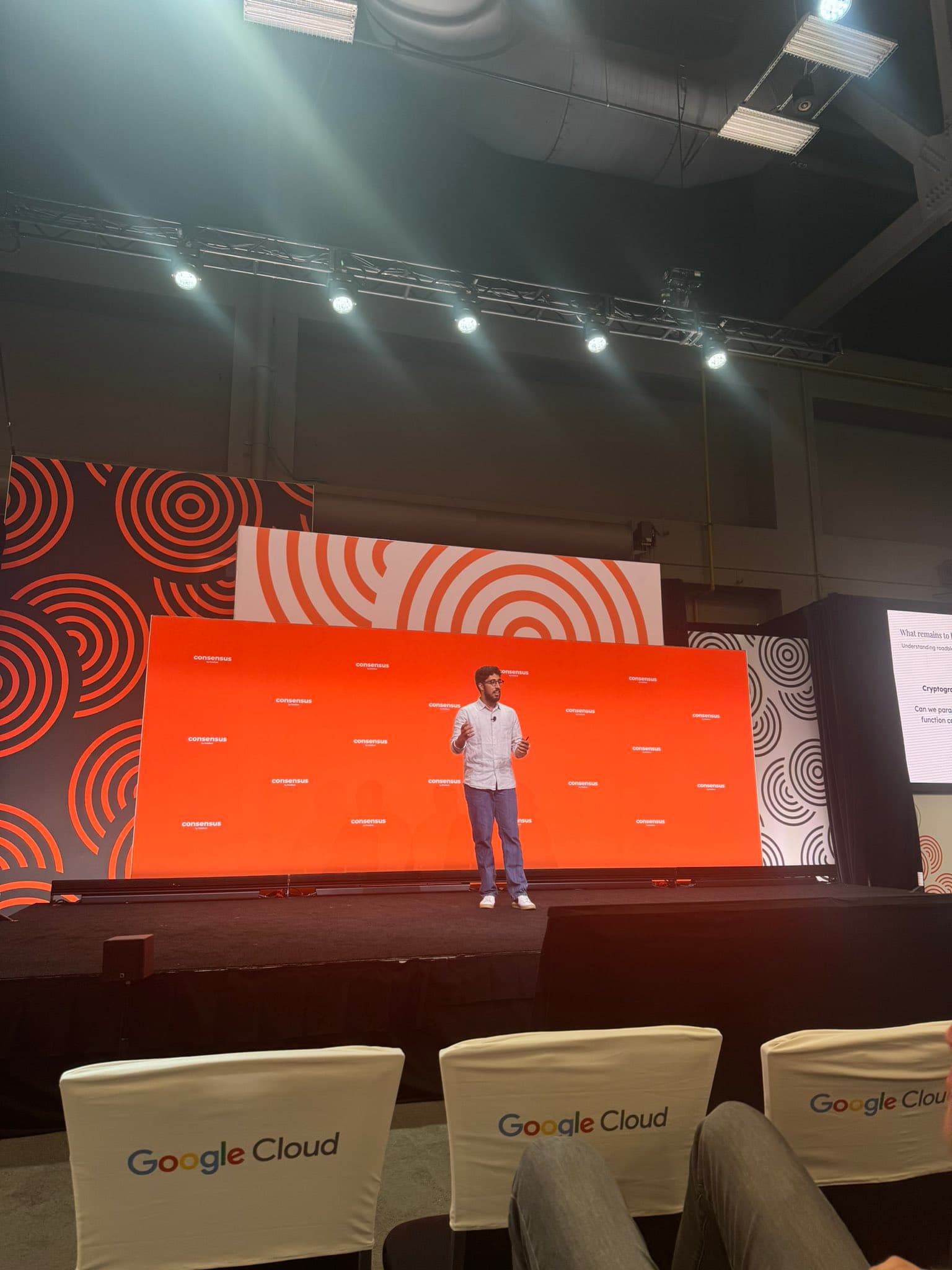 A speaker on stage at a Web3 conference